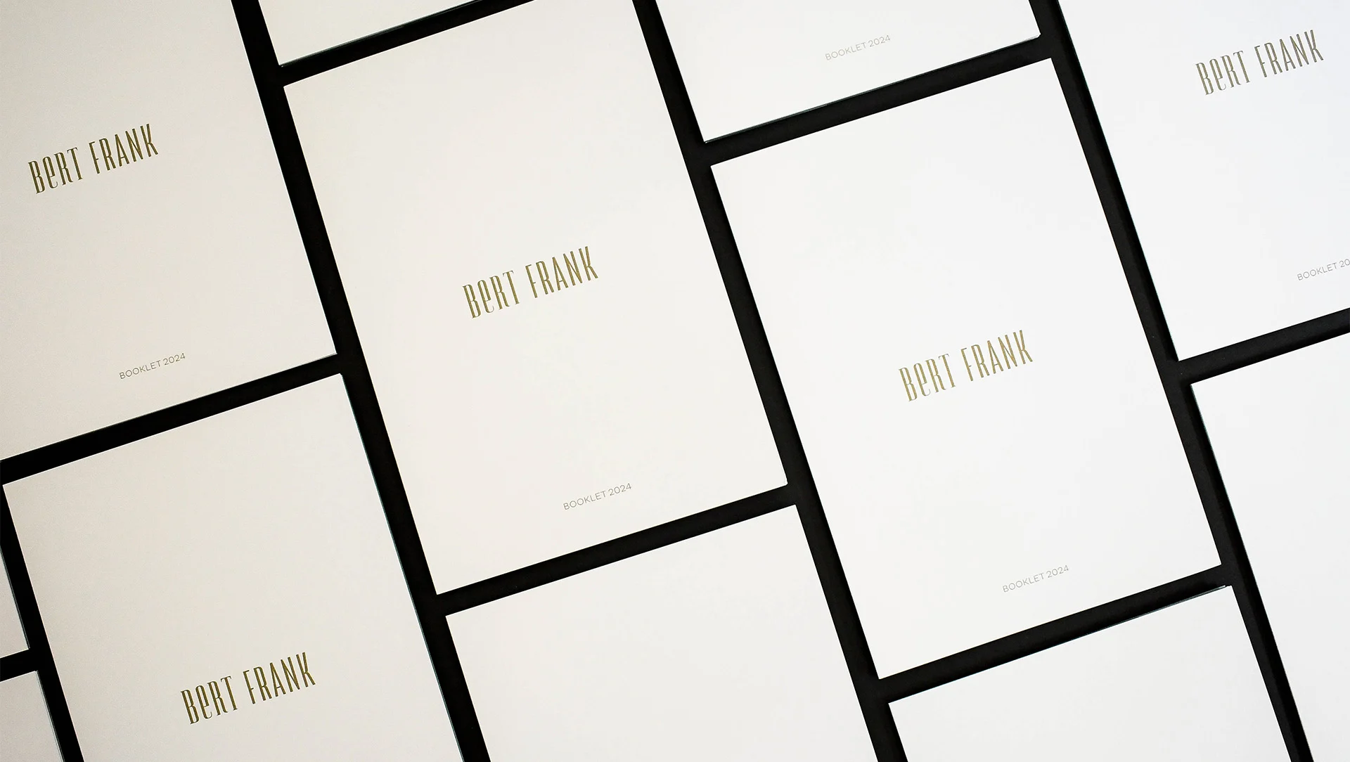 A collection of organized booklets printed for Bert Frank, elegantly displayed to highlight their quality and design.