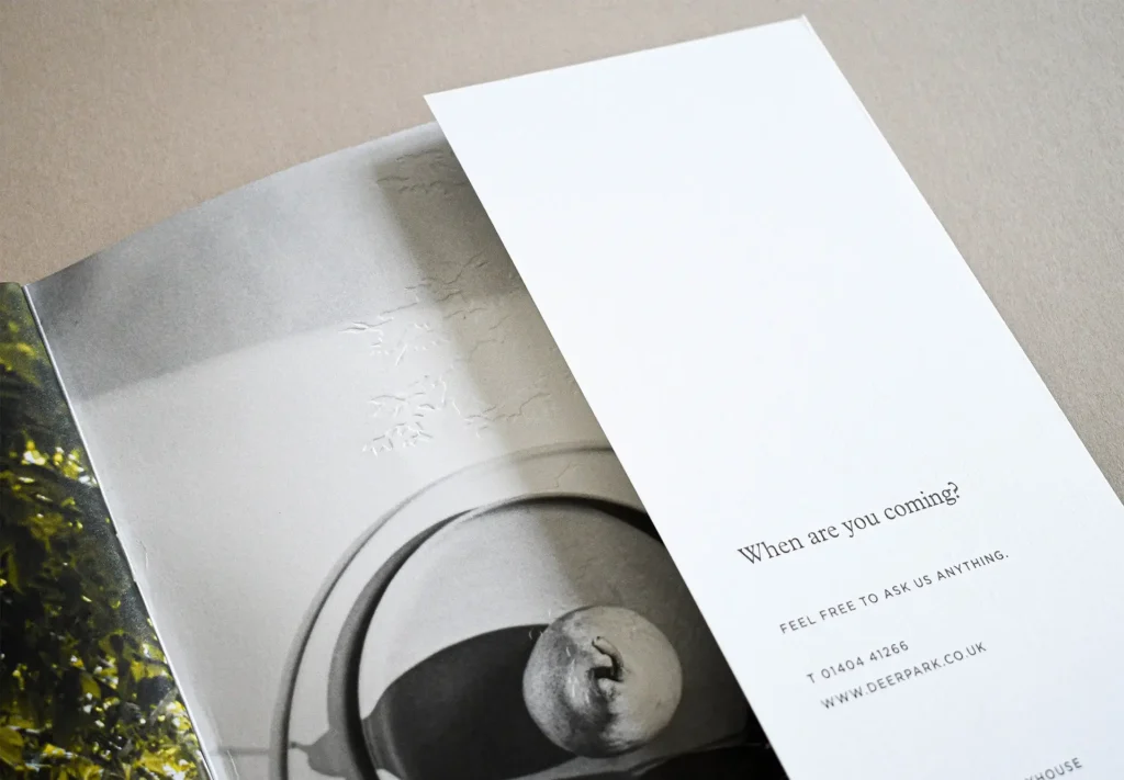 A close-up of an inside page of a hospitality brochure showing the texture of the paper and high-quality print.