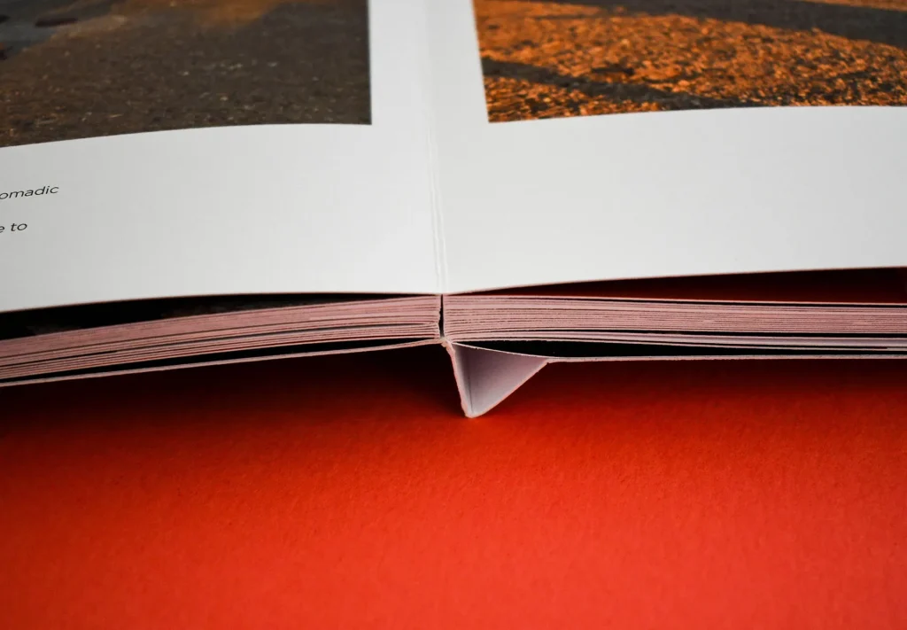 A close-up showcasing the lay-flat finish of the spine, seamlessly allowing pages to open up and create one continuous large page, enhancing the reader's experience.