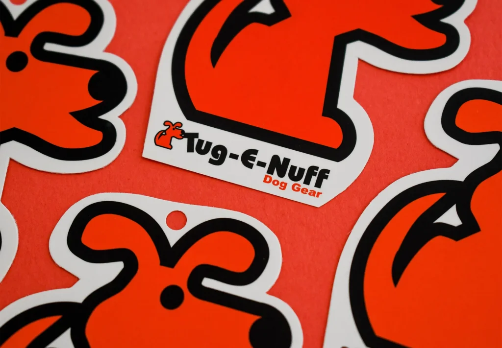 Die-cut labels tailored for retail products from Tug-E-Nuff, a leading dog gear company, designed for durability and enhanced branding impact.