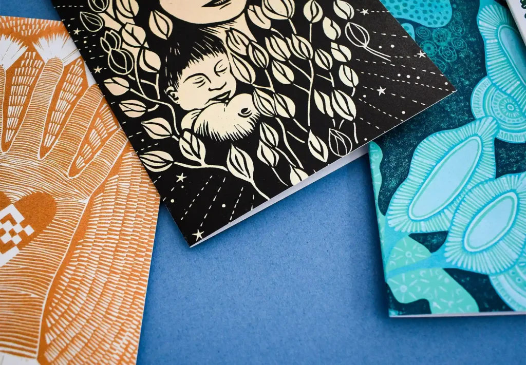 A close up of a charming collection of greeting cards featuring lino-cut illustrations