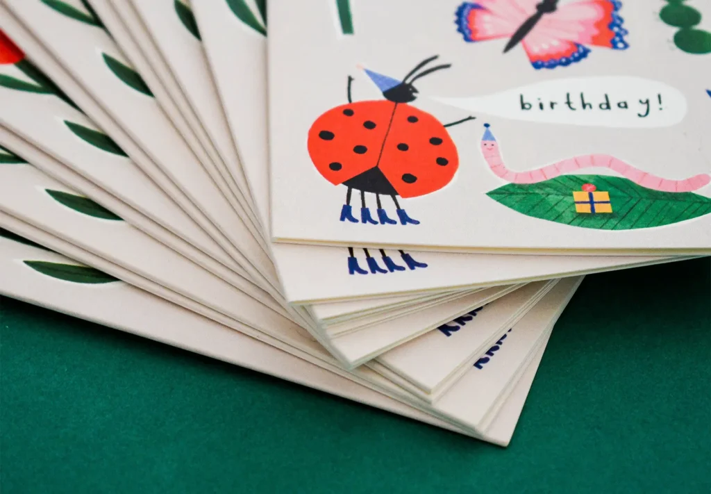 A close up of a collection of greetings cards illustrated in a fun style.