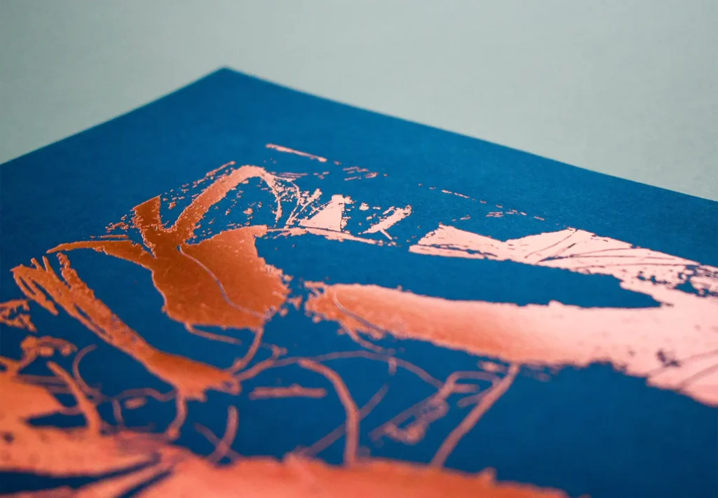 A close up of bronze foiling on a creative brochure.