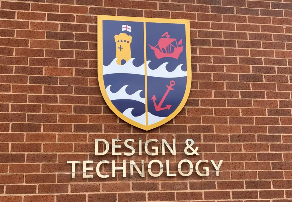 3D sign and individual lettering for a community college mounted on a brick wall, providing a stylish and professional look to the college entrance.