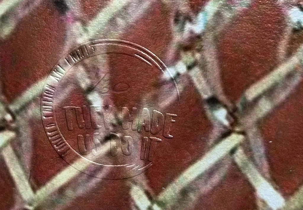 Zoomed-in image of an embossed emblem on a limited edition prints.