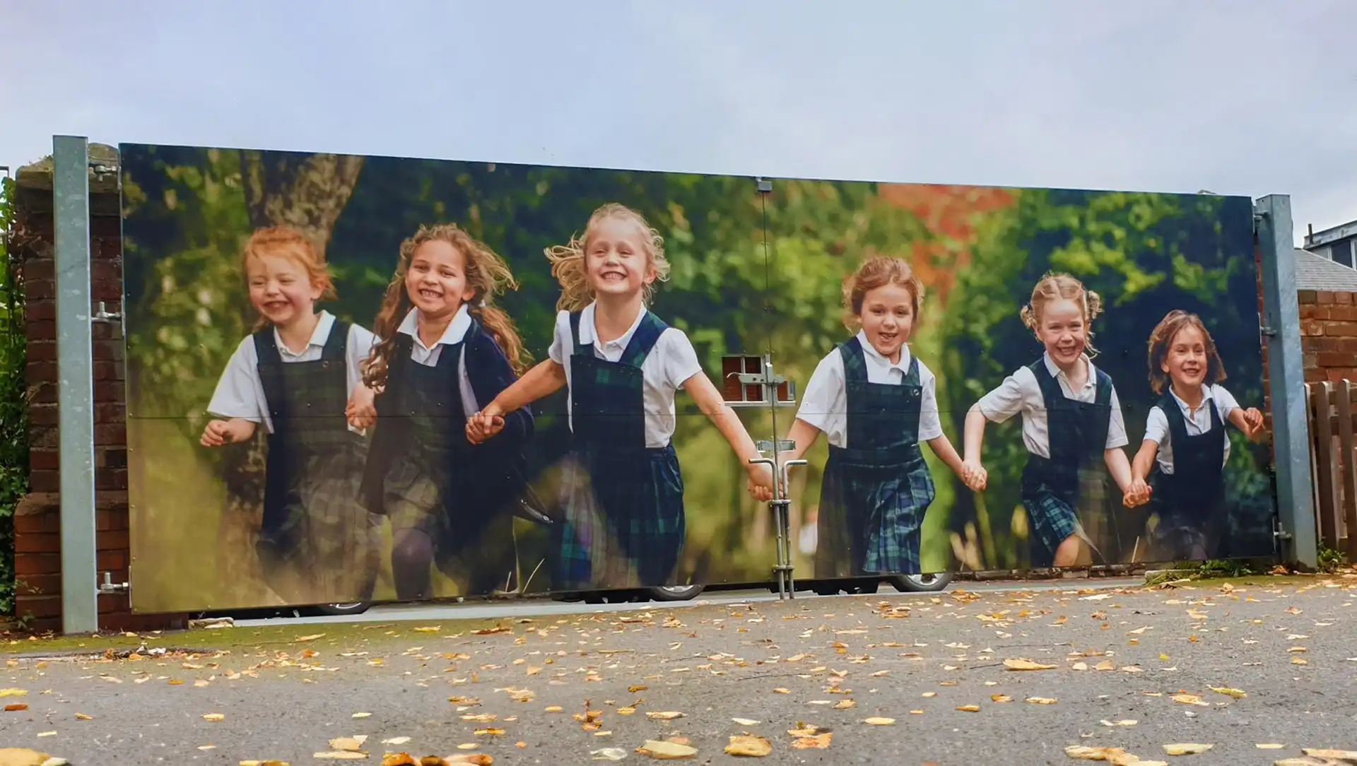 Custom wrapping produced and fitted for a school gate featuring a picture of the children.