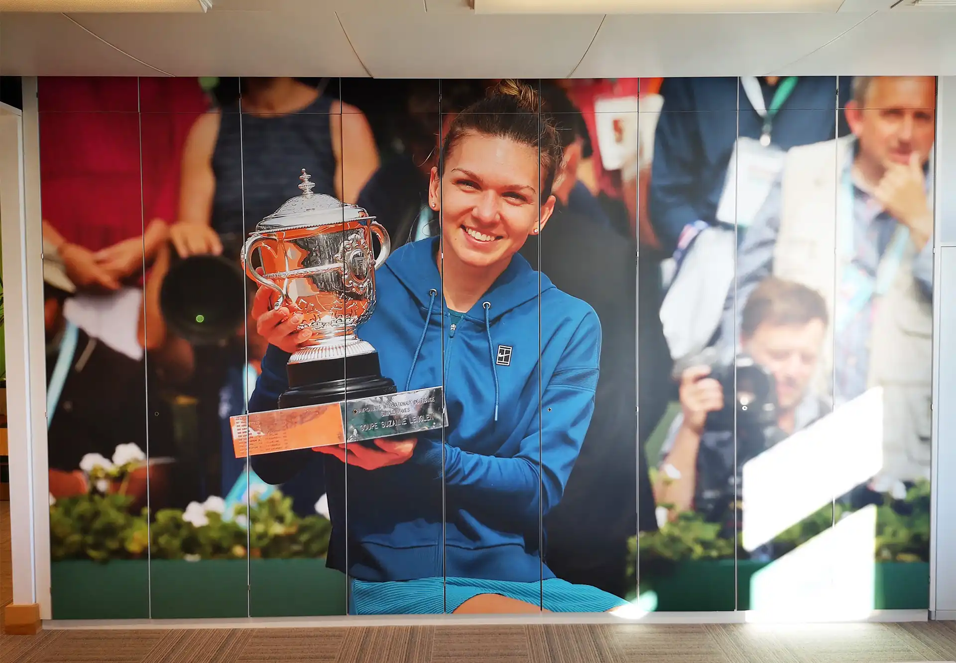 A large full wall cupboard wrapped in a sports image.