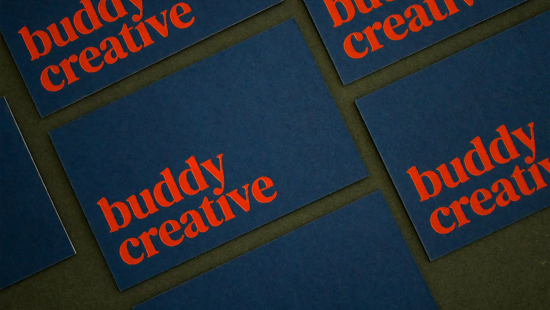 A collection of business cards crafted for Buddy Creative, showcasing debossing techniques and premium-quality card stock for a lasting impression.