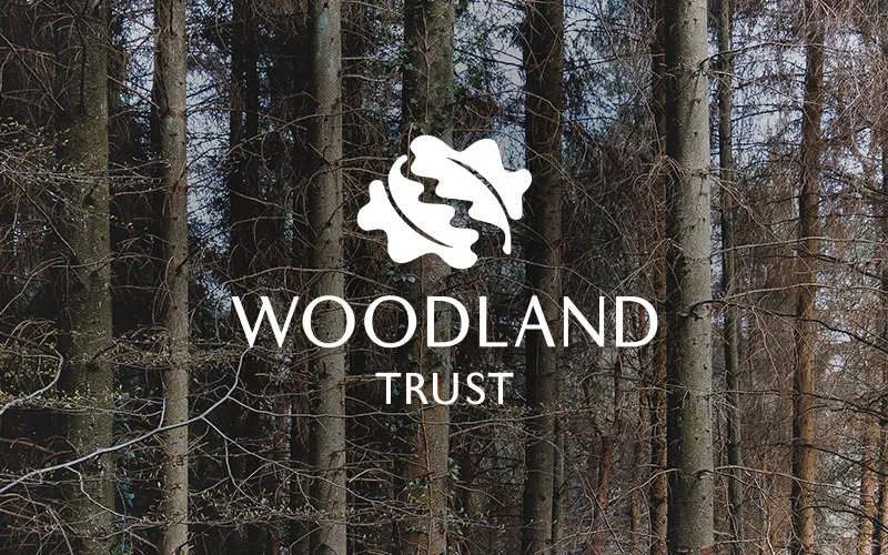 Woodland with the woodland trust logo over the top.